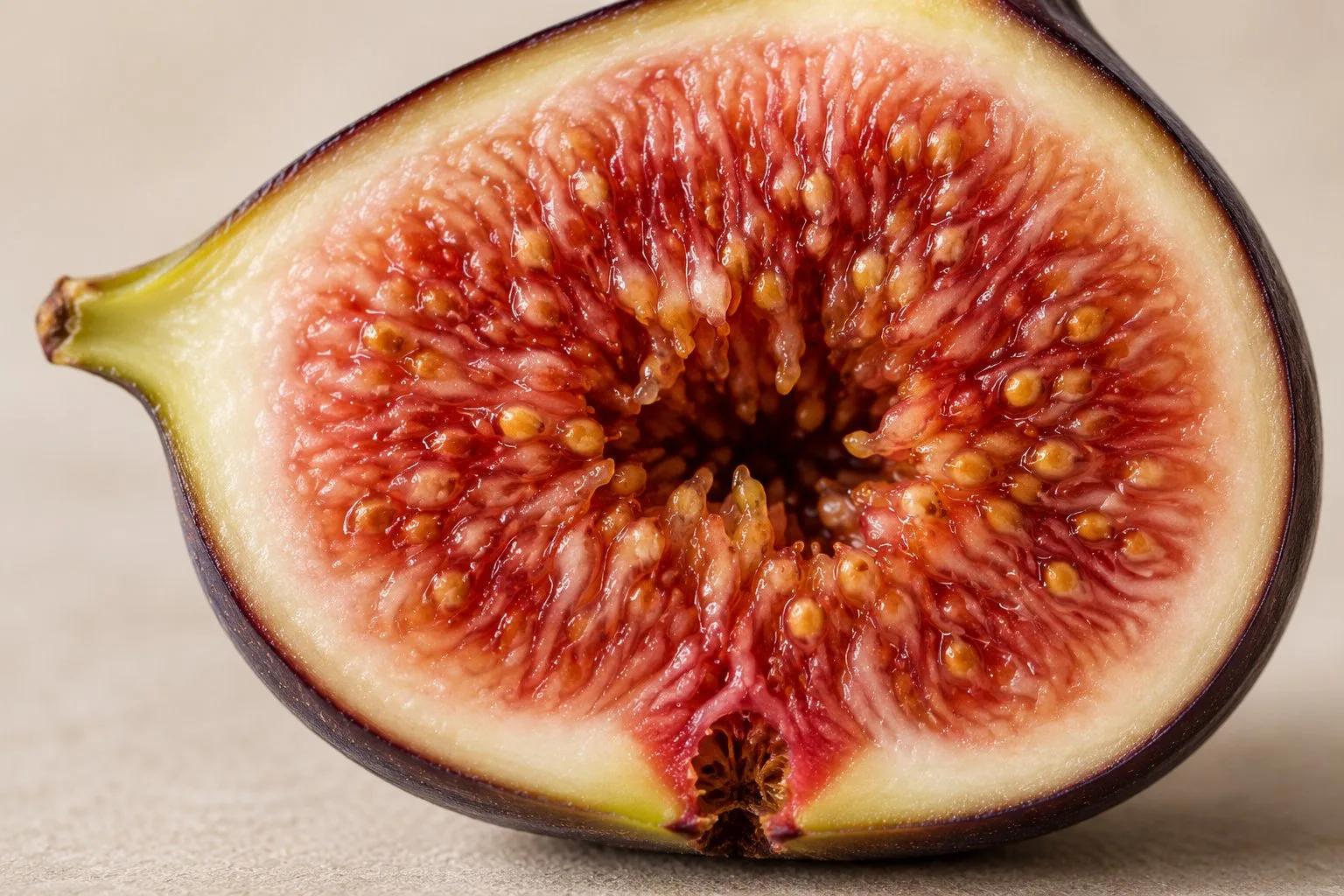 A fig cut in half showing the flowers inside